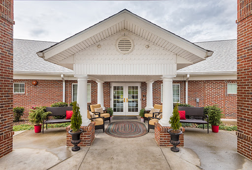 Welcoming entrance of a residential building with inviting outdoor seating.