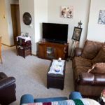 Cozy living room with sofa, television, and home decor.
