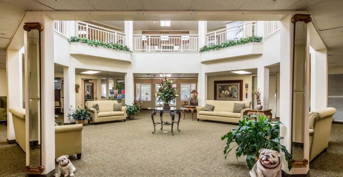 A spacious and elegantly decorated lobby area with sofas and plants.
