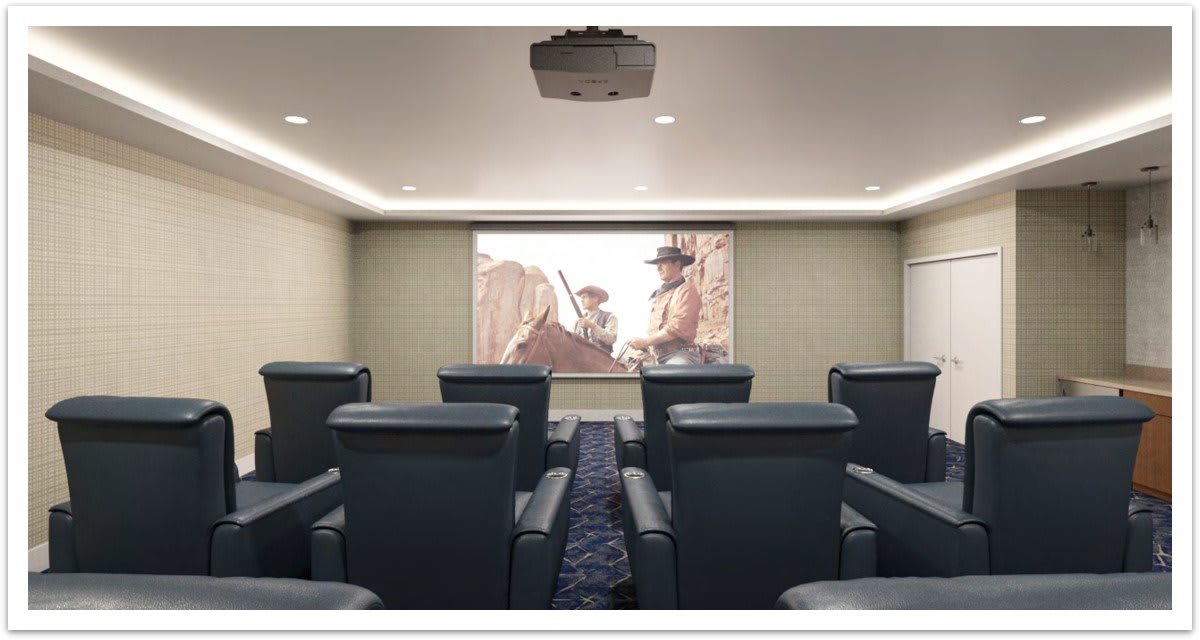 A cozy home theater setup with comfortable seating and a large projection screen.
