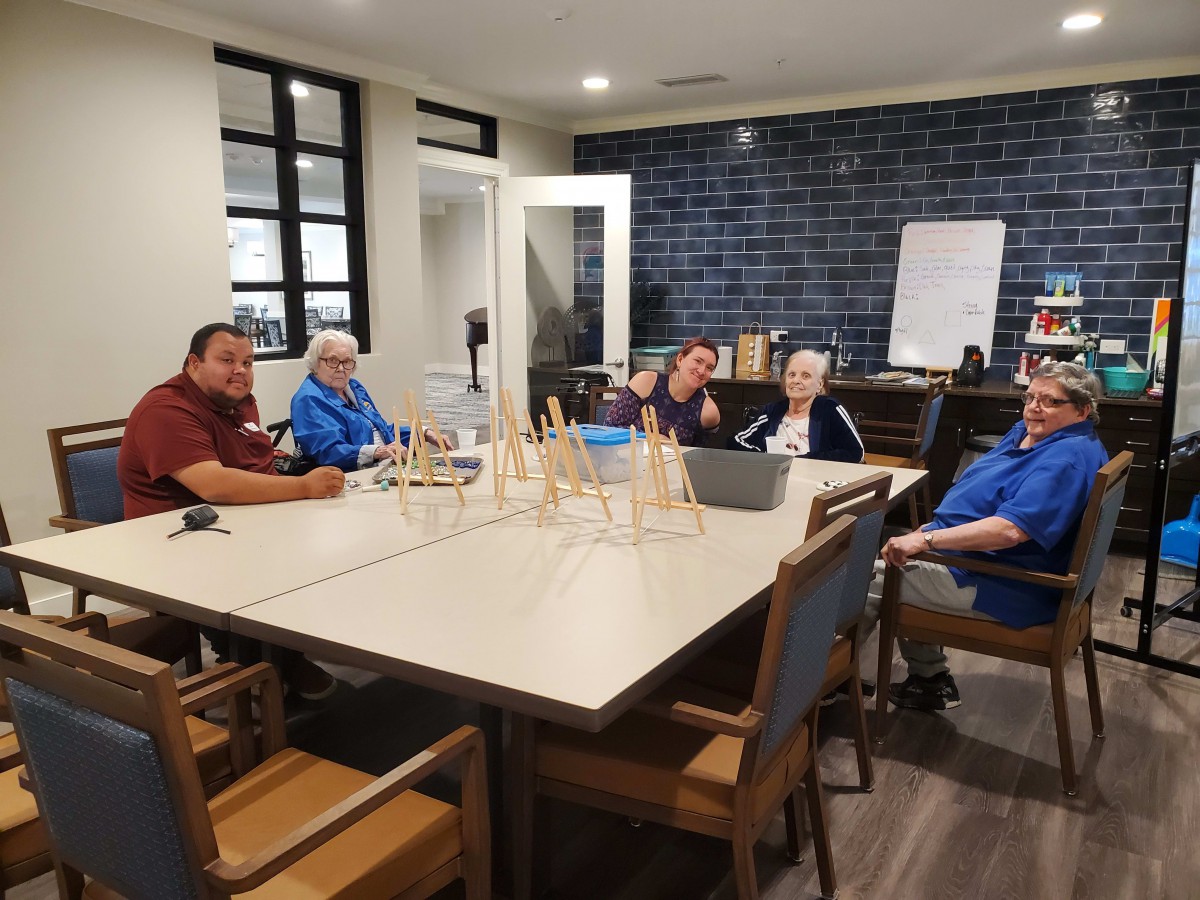 A group of people sitting around a table in a casual indoor setting.