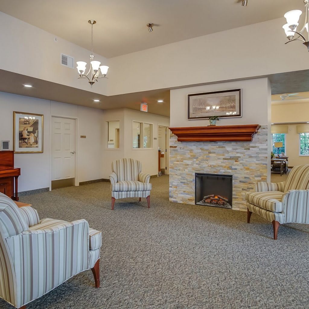 A cozy living room featuring a stone fireplace and comfortable seating.