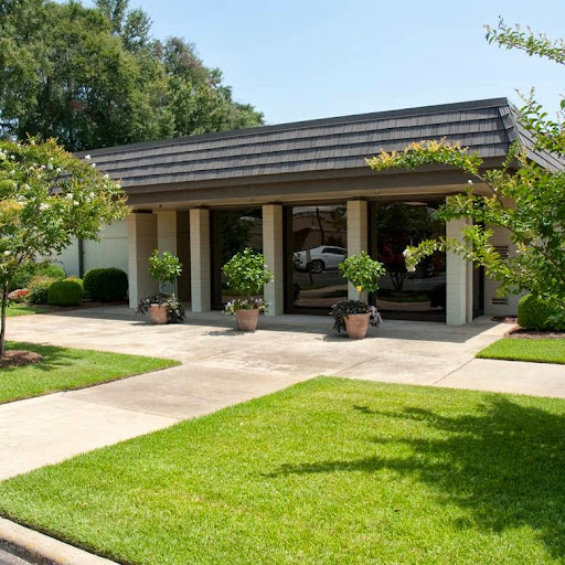 A modern commercial building featuring a landscaped front yard and a welcoming entrance.