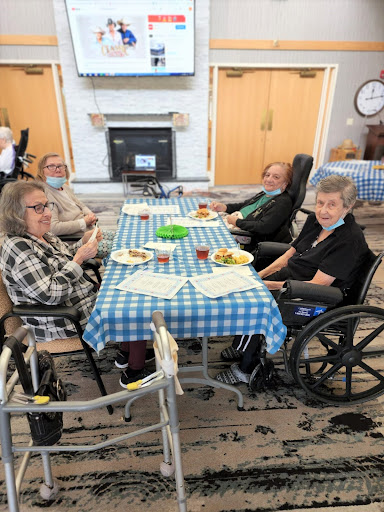 Seniors enjoying a meal together in a care facility.