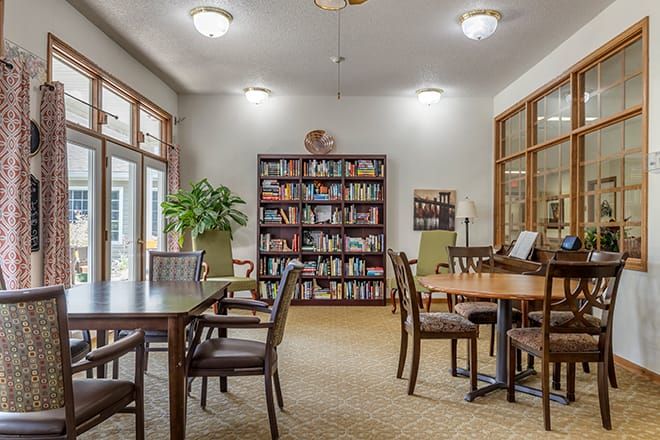 Cozy library with tables and bookshelves.