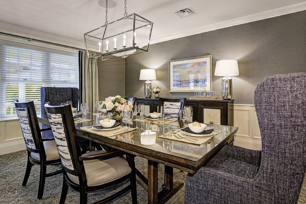 A modern dining room with elegant decor and a stylish table setting.