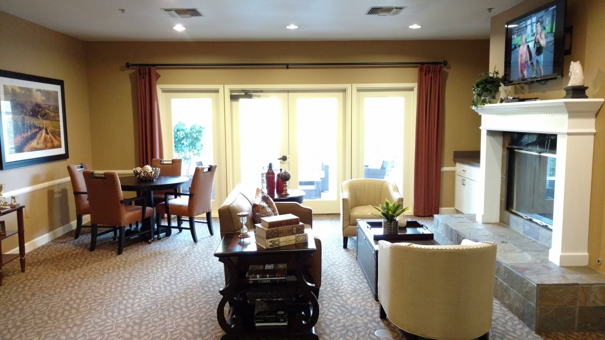 A cozy living room with comfortable seating and natural light pouring through large windows.