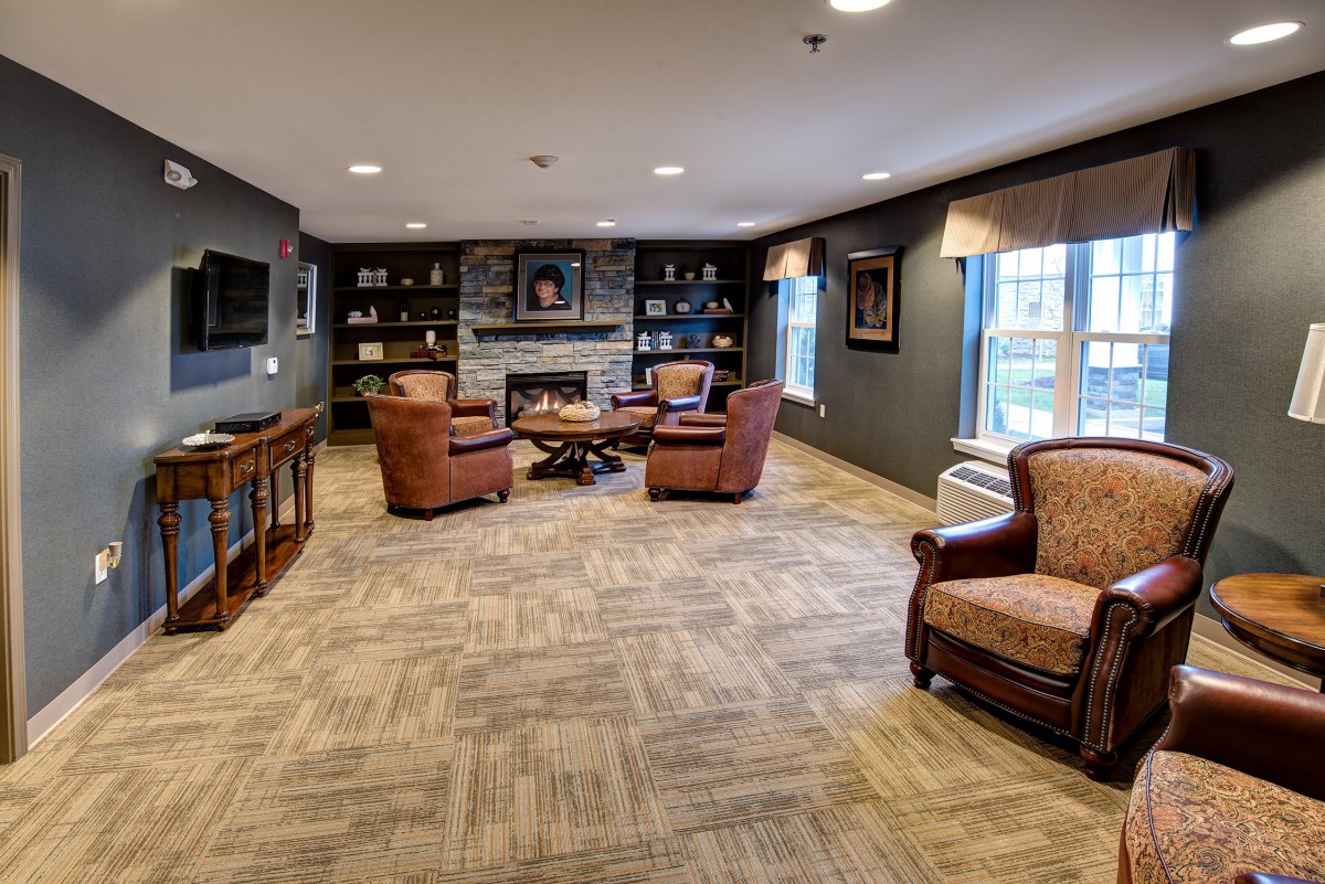 A cozy living room with comfortable seating around a fireplace.