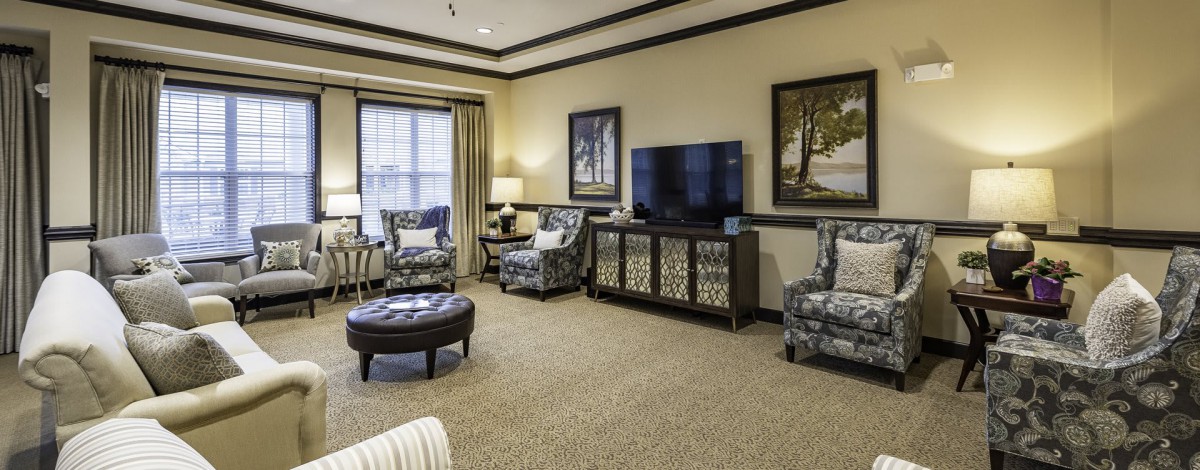 A cozy living room with comfortable seating and a large TV.