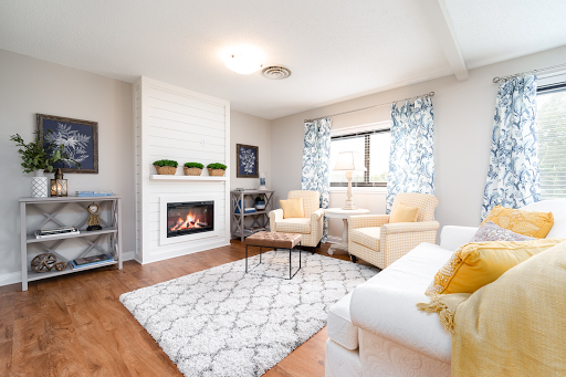 A cozy and modern living room featuring a fireplace, comfortable seating, and stylish decor.