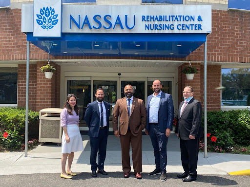 A gathering of professionals outside Nassau Rehabilitation and Nursing Center.
