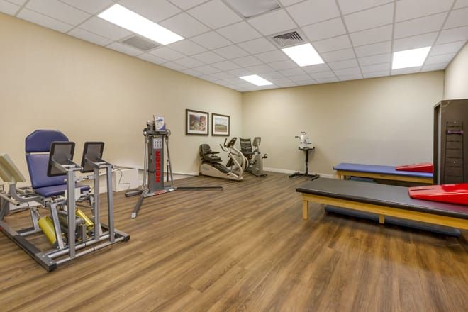 A spacious gym with exercise equipment and workout areas.