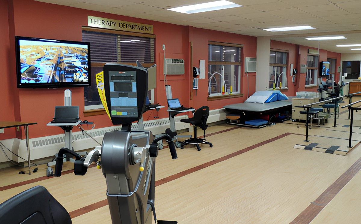 A modern gym with various exercise equipment and fitness stations.