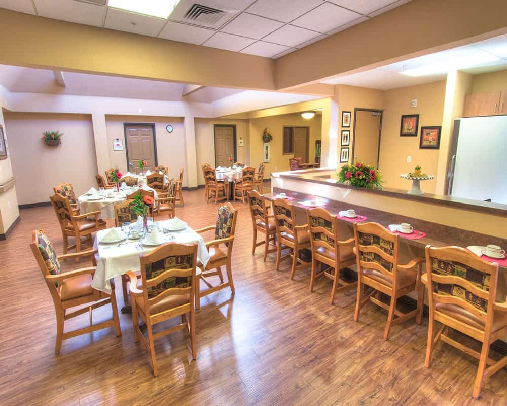 A spacious dining area with wooden furniture and warm lighting.