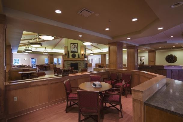 A cozy lounge area with wooden decor and comfortable seating.