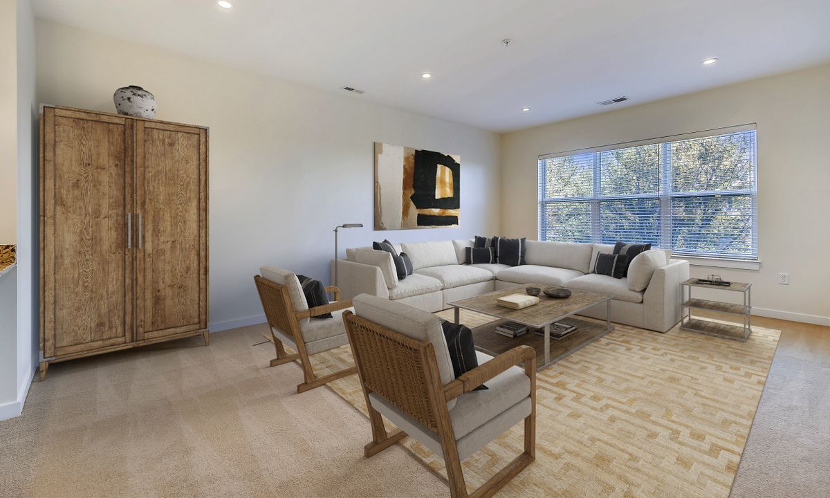 A modern living room with neutral tones and contemporary furniture.