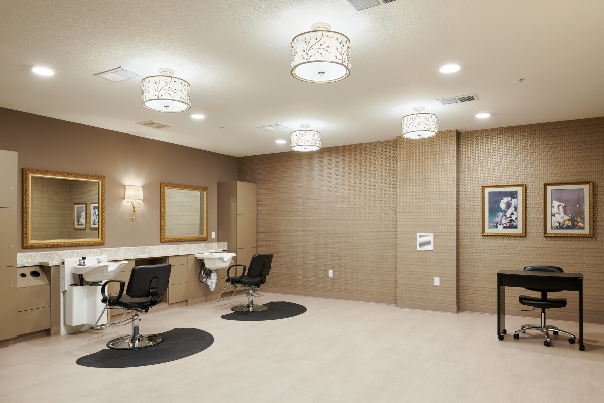 A modern salon interior with styling chairs and mirrors under elegant lighting.