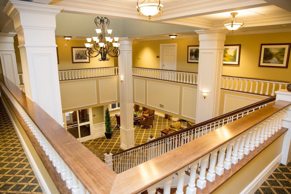 A grand hotel lobby with elegant columns and a chandelier.