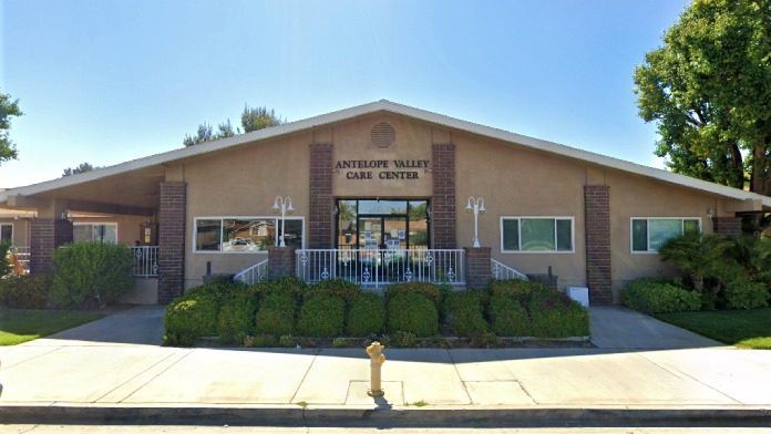 The image shows the exterior of a community center building on a sunny day.