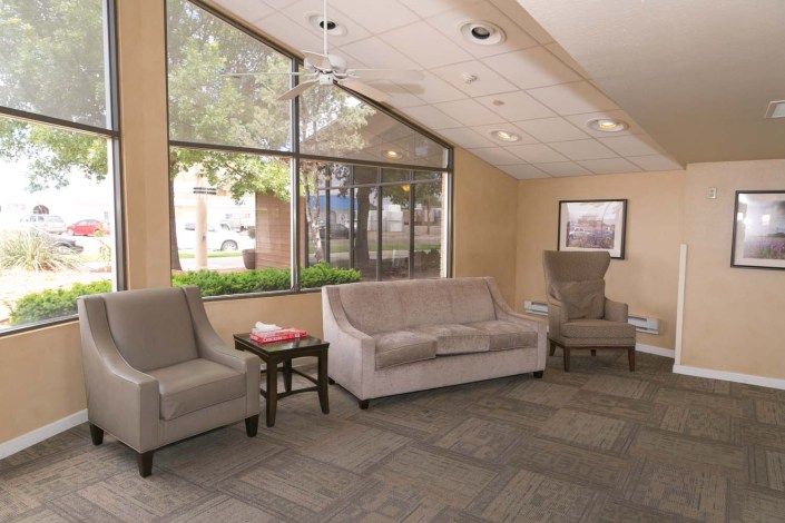 A cozy lobby area with seating and large windows.