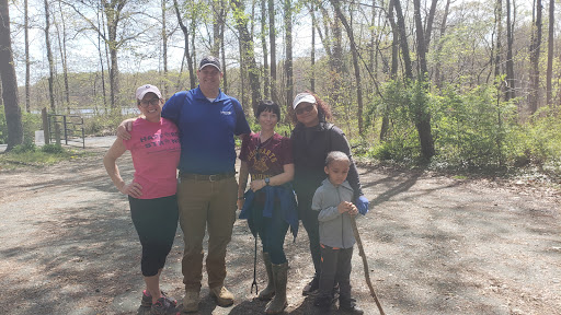 A joyful family outing in nature, enjoying the beautiful spring weather during a hike.