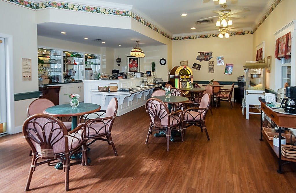 A quaint cafe interior with vintage decor and a jukebox.