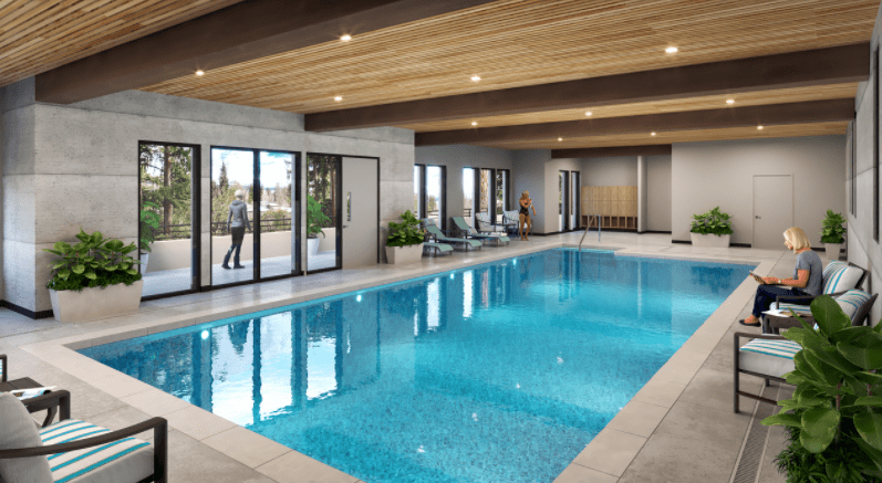 A modern indoor swimming pool with ample natural light and stylish design.