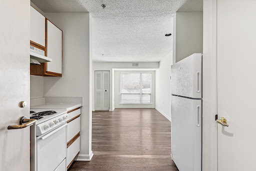 A view of an open-concept kitchen leading into a spacious living area.