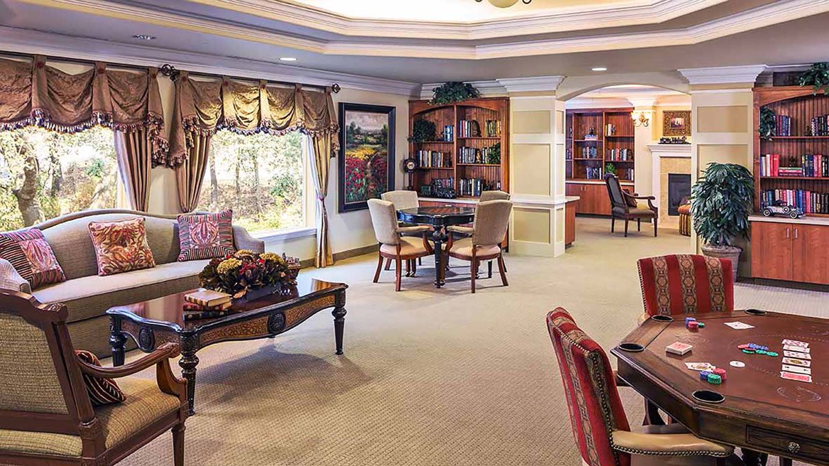 A cozy living room with comfortable seating, bookshelves, and tasteful decor.