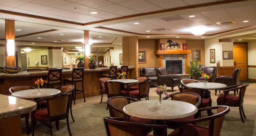 A cozy indoor lounge with dining tables and chairs, perfect for relaxation.