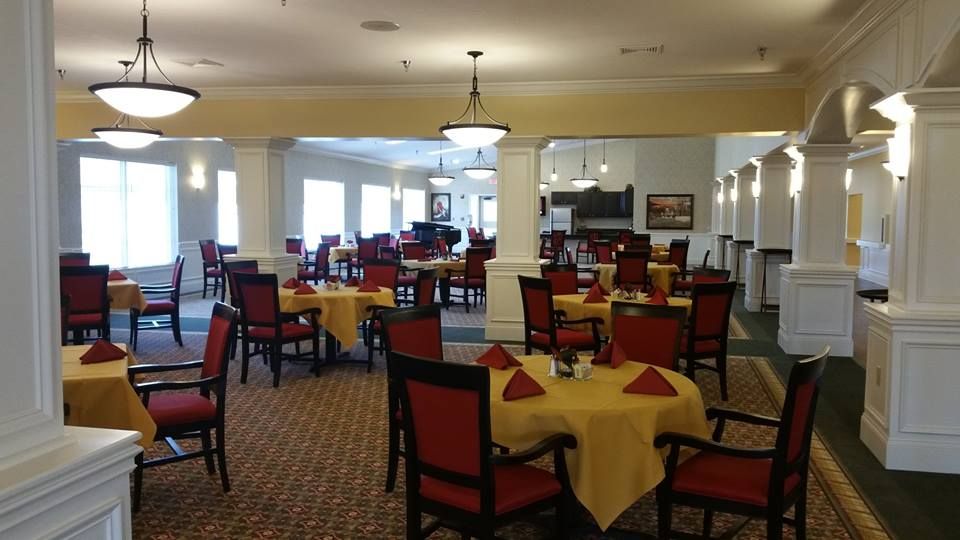 An elegant dining room with neatly arranged tables and chairs, ready for guests.