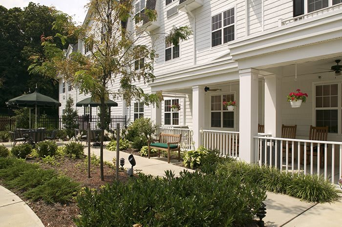 A view of a residential building with a well-maintained garden and pathway.