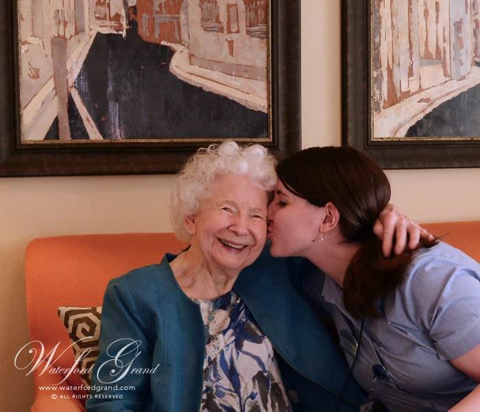 A loving moment between family members as one shares a kiss and a smile.
