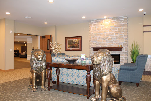A stylish lobby featuring decorative lion statues flanking a wooden console table.