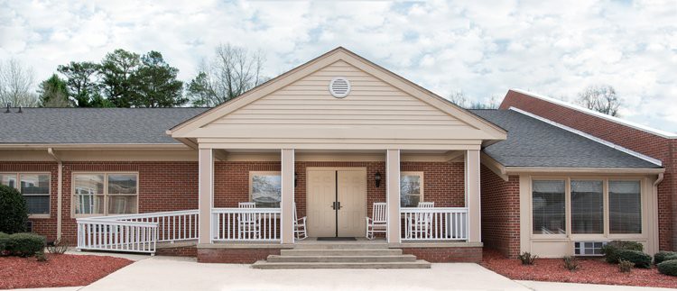 A suburban house with a front porch and columns.