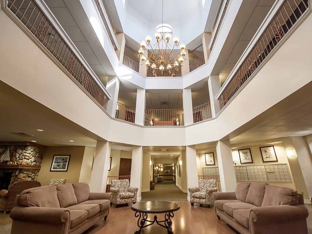 Elegant hotel lobby featuring a grand chandelier and comfortable seating.