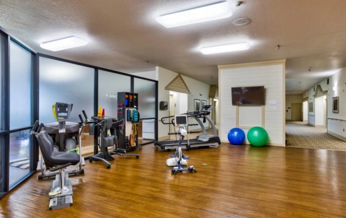 A well-equipped gym with various exercise machines and fitness equipment.