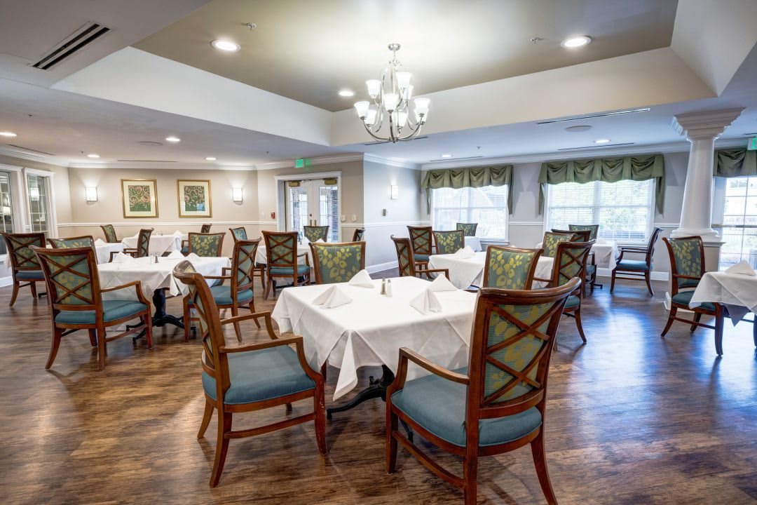Elegant dining area with neatly arranged tables and chairs.