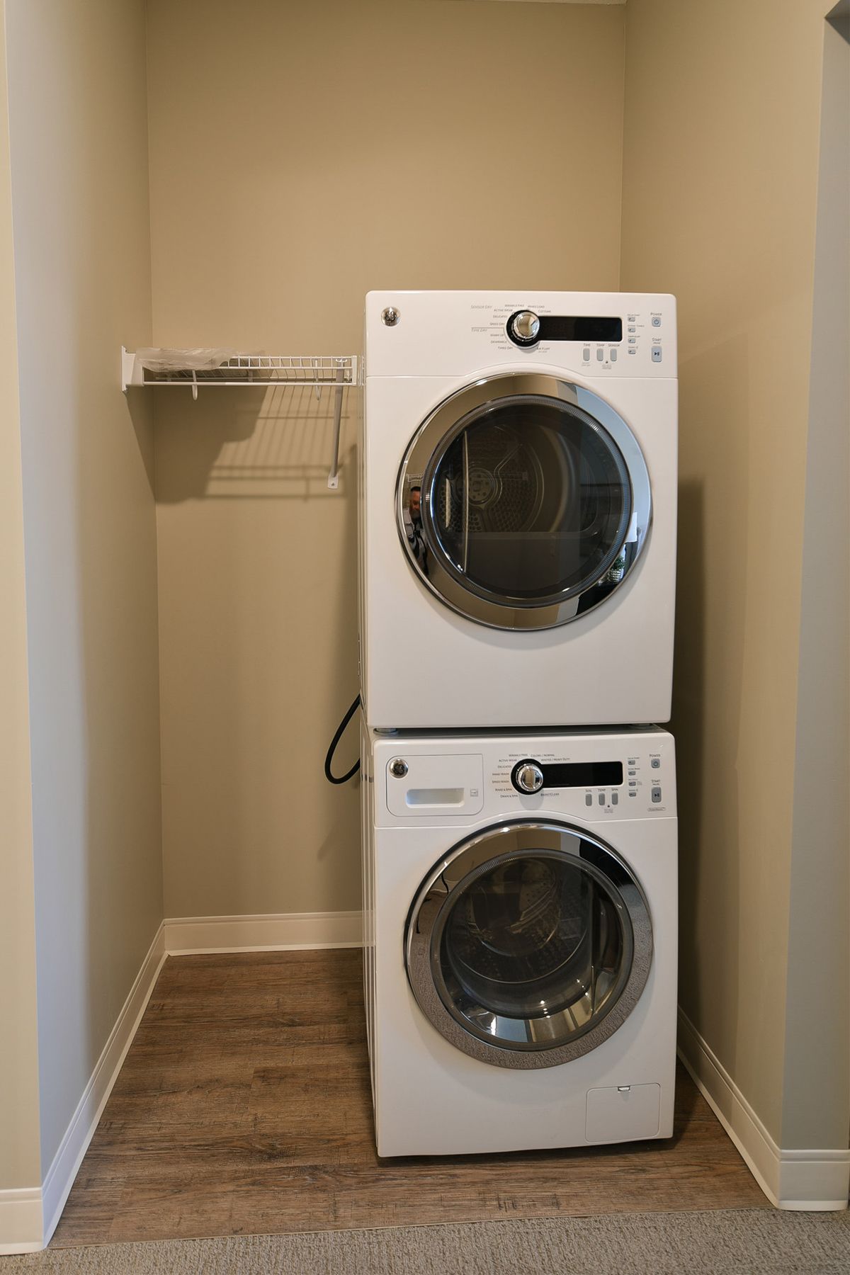 A stacked washer and dryer set inside a compact laundry space.