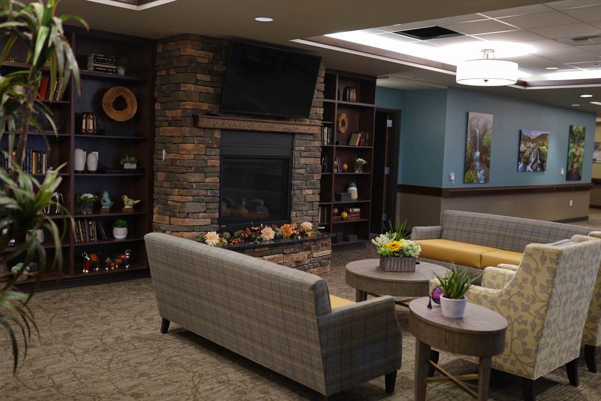A cozy living room with a fireplace and modern decor.