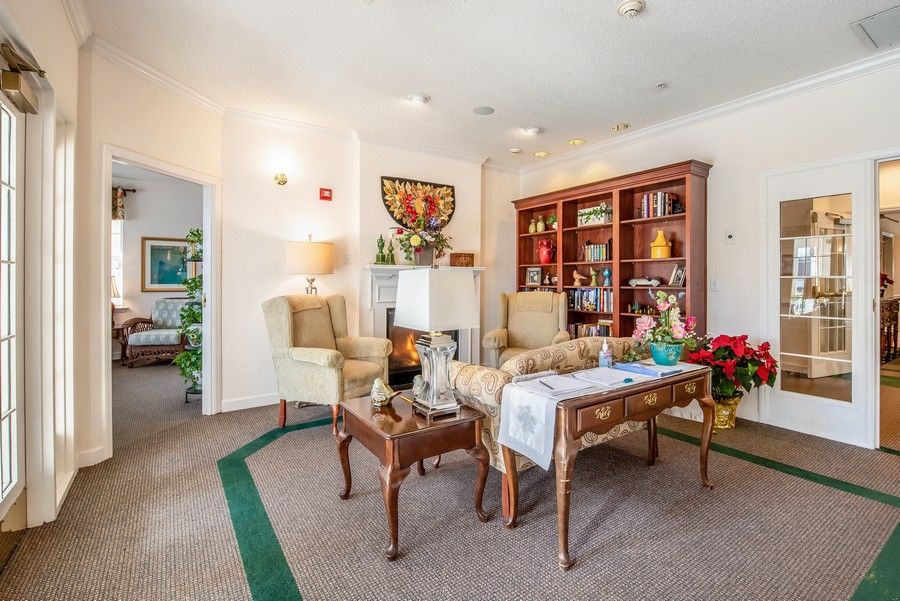 A cozy living room with elegant furniture and a well-stocked bookshelf.