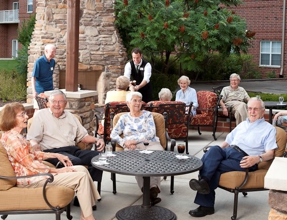 A group of seniors enjoying an outdoor gathering on a patio.