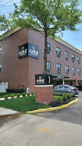 Exterior view of a hotel with modern signage and landscaped surroundings.