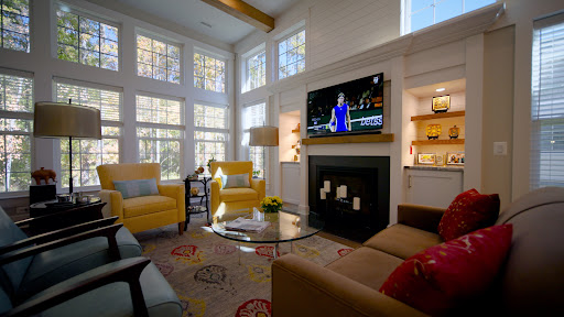 A bright and inviting living room featuring modern furnishings, a cozy fireplace, and ample natural light.