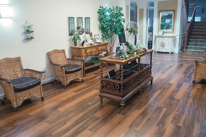 A cozy reception area with elegant wooden furniture and decorative elements.