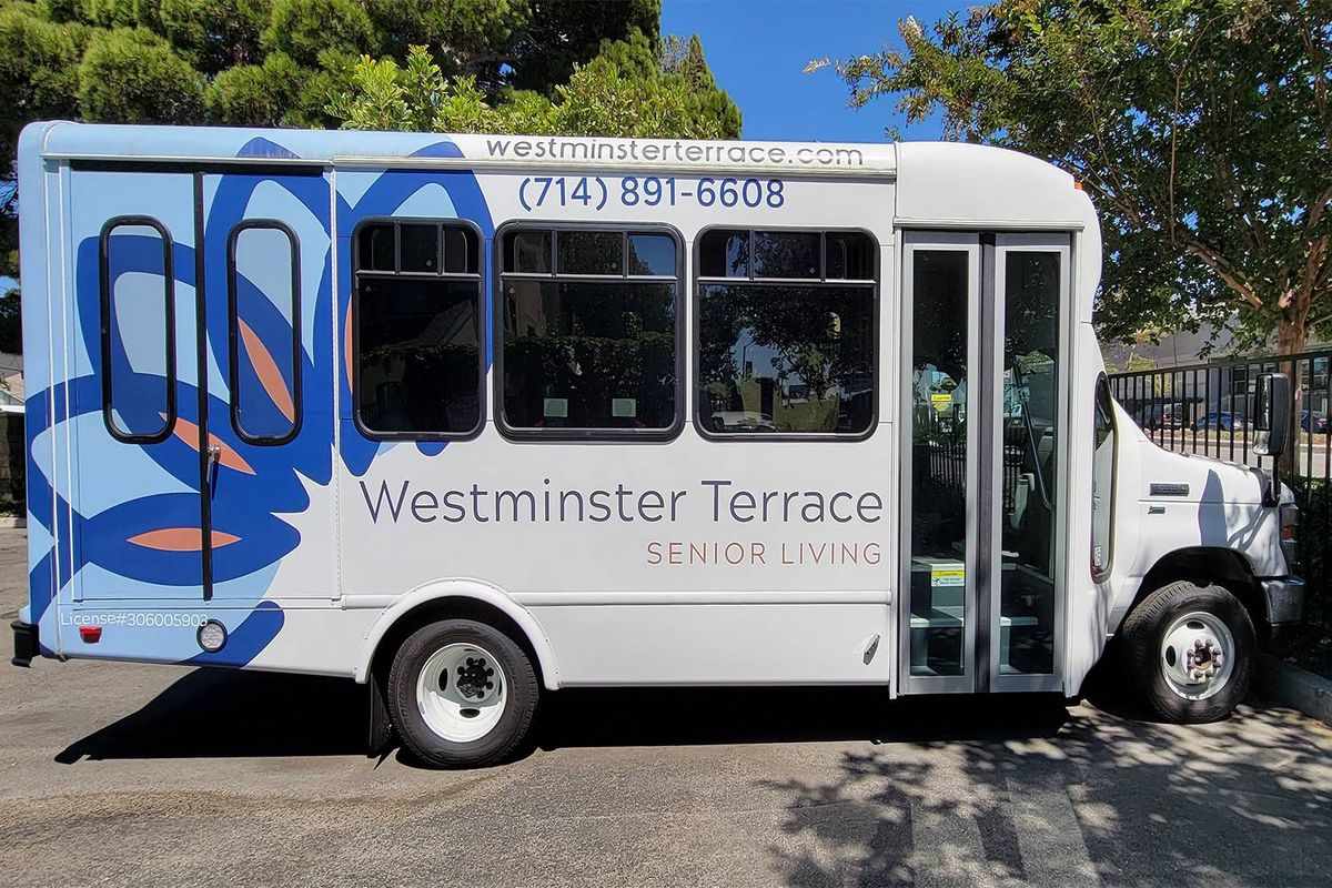 A bus for Westminster Terrace Senior Living parked on the roadside.