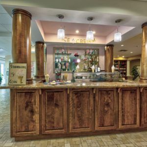 Elegant hotel reception area with a wooden counter and decorative elements.