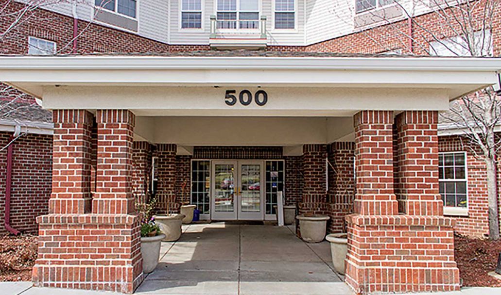 A brick building entrance with the number 500 displayed above the doorway.