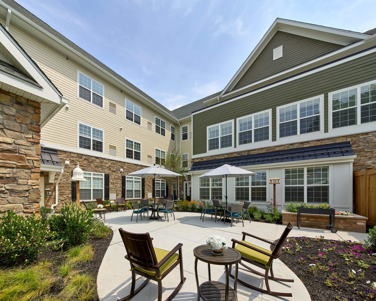 A modern residential courtyard with outdoor seating and greenery.