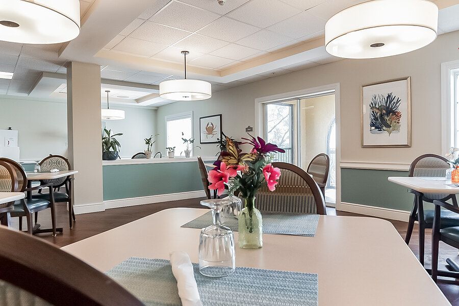 A modern dining area with stylish decor and floral centerpiece.